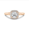 2.50 carat solitaire halo ring with a cushion diamond in red gold with round diamonds