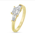 1.00 carat trilogy ring in yellow gold with a lab grown princess diamond and lab grown tapered baguettes