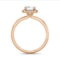 3.00 carat solitaire halo ring with a emerald cut diamond in red gold with round diamonds