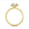 1.00 carat solitaire halo ring with a emerald cut diamond in yellow gold with round diamonds