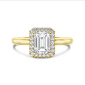 1.00 carat solitaire halo ring with a emerald cut diamond in yellow gold with round diamonds