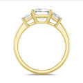4.40 carat trilogy ring in yellow gold with emerald cut diamonds