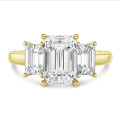 4.40 carat trilogy ring in yellow gold with emerald cut diamonds