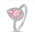 1.50 carat solitaire white halo ring with pink side halo and pink pear diamond and side diamonds in white gold