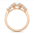 Trilogy ring with a 3.00 carat oval diamond with side pear diamonds of 0.35 carat each in red gold