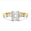 2.00 carat trilogy ring in yellow gold with a lab grown emerald cut diamond and lab gown tapered baguettes