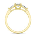 2.00 carat trilogy ring in yellow gold with lab grown oval diamond and lab grown tapered baguettes