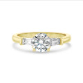 2.00 carat trilogy ring in yellow gold with round lab grown diamond and lab grown tapered baguettes