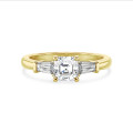2.00 carat trilogy ring in yellow gold with a lab grown asscher cut diamond and lab grown tapered baguettes