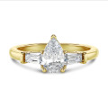 3.00 carat trilogy ring in yellow gold with lab grown pear diamond and lab grown tapered baguettes