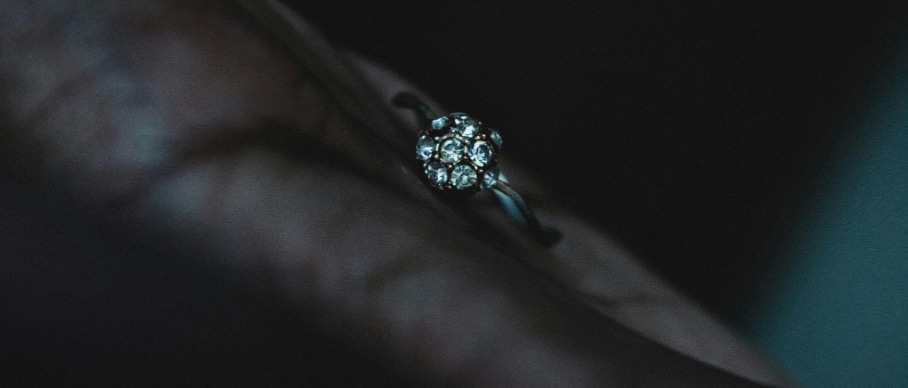 Diamond ring on a hand in the dark