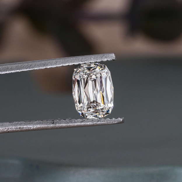 Old mine cut lab-grown diamond held by diamond tweezers