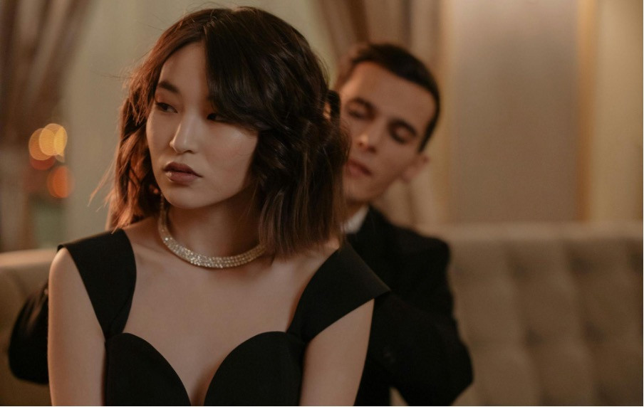 Asian woman wearing a diamond necklace.